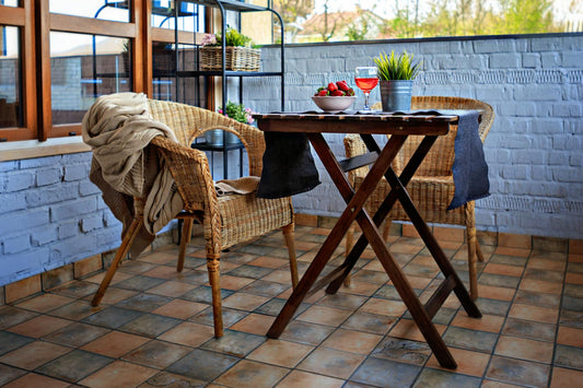 Compact garden dining table styled on a small British patio with outdoor seating